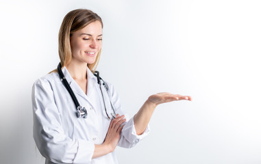 Medical concept of young female doctor in white coat with stethoscope copy space