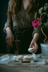 Girl holding a macaron cookie