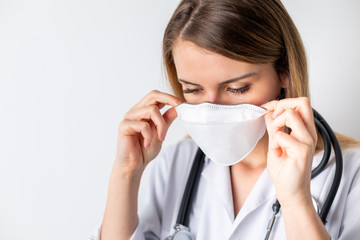 Virus mask female doctor puts on face protection in prevention for coronavirus