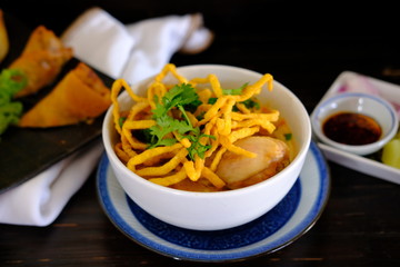 Noodle soup with chicken on wood table