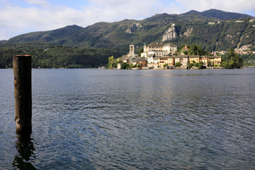 Fototapeta premium Orta San Giulio (NO), Italy - September 02, 2019: Landscape of San Giulio Island on Lake Orta, Novara, Piedmont, Italy