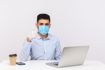 Fototapeta na wymiar Businessman with hygienic mask and gloves, showing thumb up, recommending effective protect filter to prevent contagious disease coronavirus, 2019-nCoV, flu epidemic. studio shot, white background