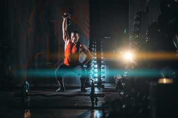 young athlete has physical workout with barbell in modern gym