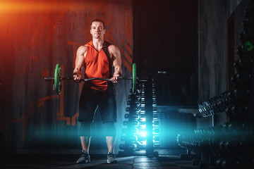 young athlete has physical workout with barbell in modern gym