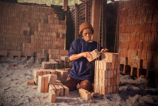 Asian women worker Preparing bricks for building a house at construction site