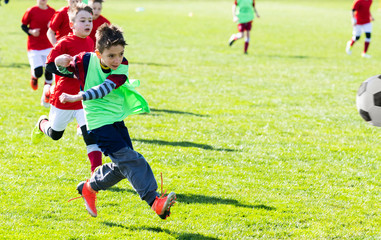 Obraz premium Boys play soccer sports field