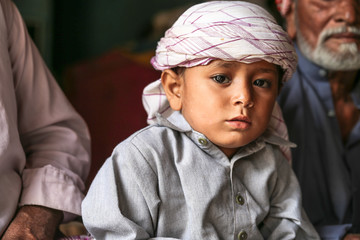 Fototapeta premium a depressed Arab grand father with his young cute grandson 