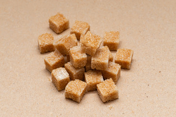 brown refined sugar cubes on craft paper background