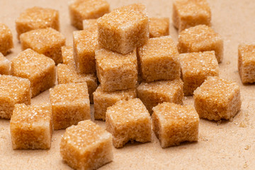 brown refined sugar cubes on craft paper background