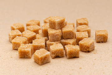 brown refined sugar cubes on craft paper background