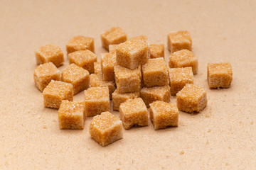 brown refined sugar cubes on craft paper background
