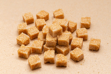 brown refined sugar cubes on craft paper background