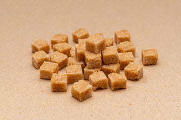 brown refined sugar cubes on craft paper background