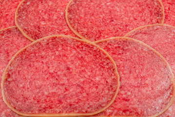 Tasty salami slices background.