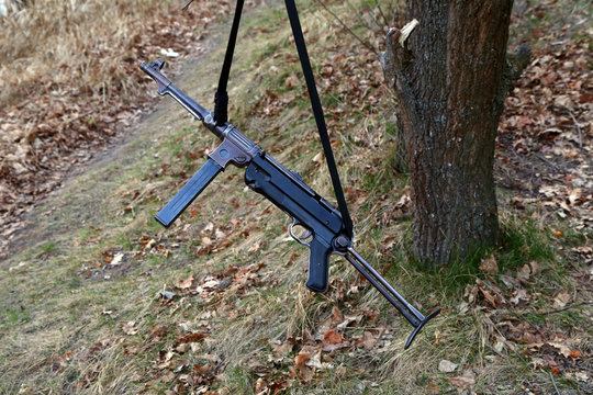 German submachine gun MP-40 on a tree branch on the lake