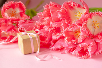 Present or gift box with Beautiful bouquet of pink tulips flowers on pink background. Card Concept for Mothers day, 8 March, Happy Birthday