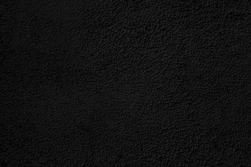 Abstract black background. Black stucco texture. Dark rough surface.