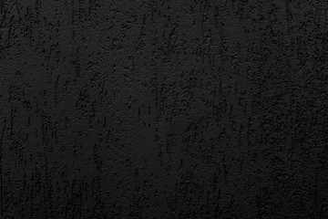 Abstract black background. Black stucco texture. Dark rough surface.