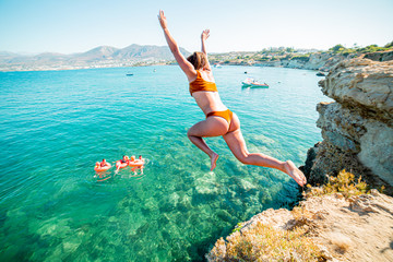 girl in the sea jumping of cliff
