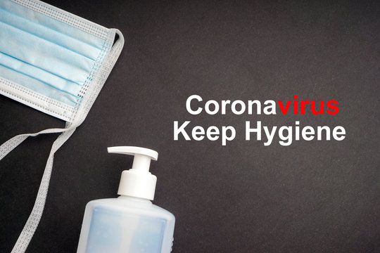 CORONAVIRUS KEEP HYGIENE text with antibacterial soap sanitizer and protective face mask on black background. Covid-19 or Coronavirus Concept
