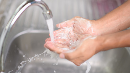 Fototapeta premium Hygiene concept. Washing hands with soap under the faucet with water
