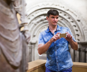 Man taking pictures in historical museum