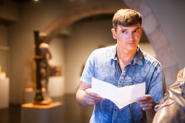 Man visiting museum with leaflet