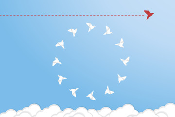 Think differently concept. Be different. Red bird changing direction. New idea, change, trend, courage, creative solution, innovation and unique way concept	