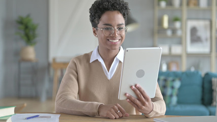 The Smiling African Girl Watching Video on Tablet