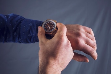 man looks at his watch