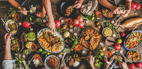 Flat-lay of family feasting with Turkish cuisine lamb chops, quince, bean, vegetable salad,...