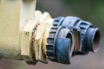 Old damaged and rusty iron oil pipe valve. Metal, pipeline and mechanic concept.