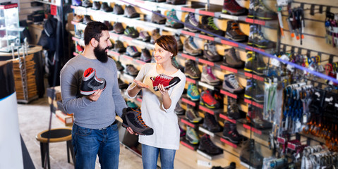 Fototapeta na wymiar Couple deciding on new sneakers