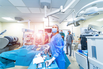 Medical team performing surgical operation in bright modern surgery room. Operating theatre. Modern...