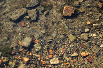 Stream in nature with the ruins of buildings and waste. Flooded building materials after the flood. Background with water for design