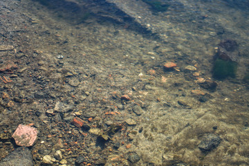 Stream in nature with the ruins of buildings and waste. Flooded building materials after the flood. Background with water for design