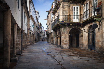 Naklejka na ściany i meble Pedestrian street and historic building facades in old town Santiago de Compostela, Spain.