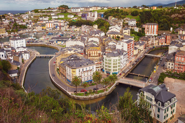 Natural urban landscape with fishing port and boats, crosses the Negro river before emptying into the sea. Location pilgrim route to St James way, tourist destination Luarca, Spain