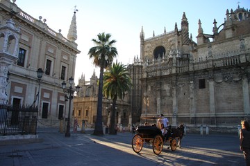 Naklejka na ściany i meble Horse-drawn carriage in the center of old Seville