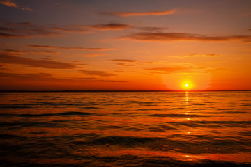 Beautiful colorful sunset on the sea coast. Nice scene with sunrise over water