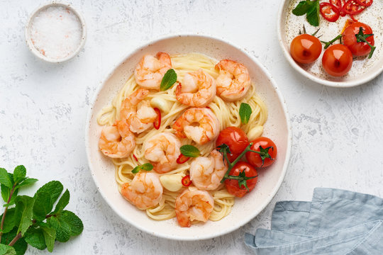 Pasta Bavette With Fried Shrimps, Bechamel Sauce, Mint Leaf, Garlic, On White Plate, Top View