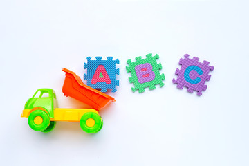 Obraz premium Colorful Kids toys with english alphabet puzzle on white background. Education concept