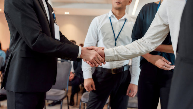 Because business matters. Cropped shot of diverse businesspeople having conversation standing together at meeting, men colleagues shaking hands at training conference.