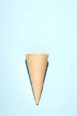 empty waffle cup for ice cream on a blue background. copy space