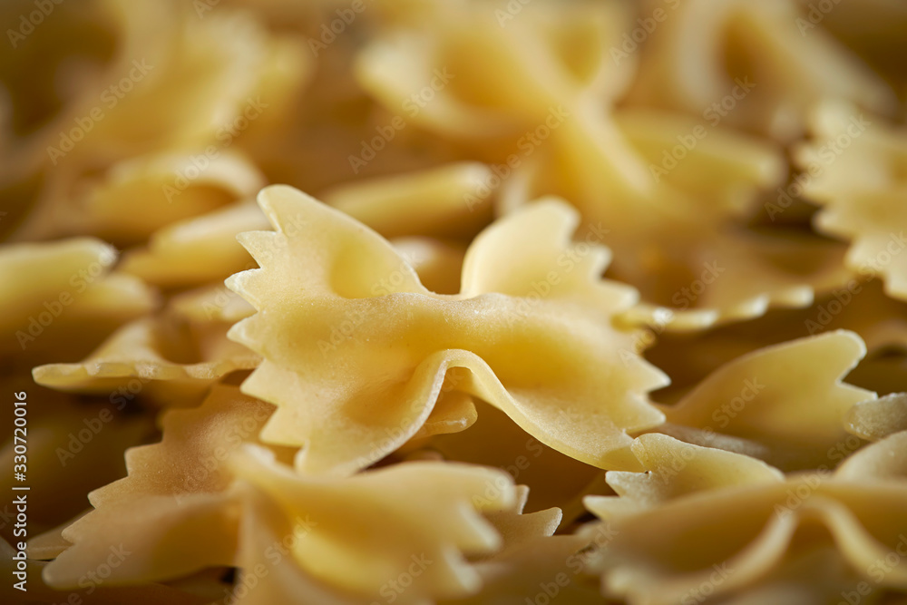 Poster Dried farfalle short pasta background 