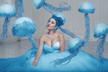 Beautiful female with blue hair and jellyfish