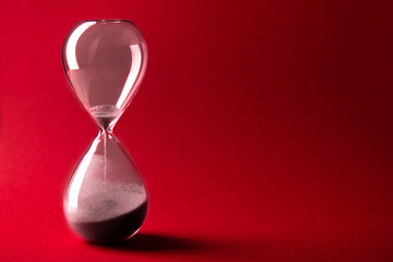 Red hourglass on a background