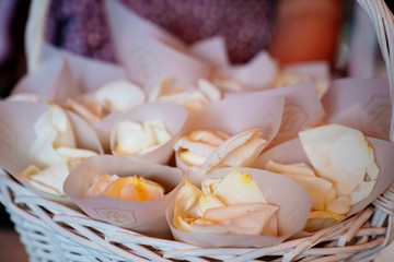 rose petals in envelopes for guests in basket.