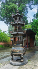 Bronze carved censer where monks make incense offerings. Central courtyard in Shaolin temple,...