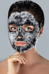Woman with  bubble sheet mask on her face